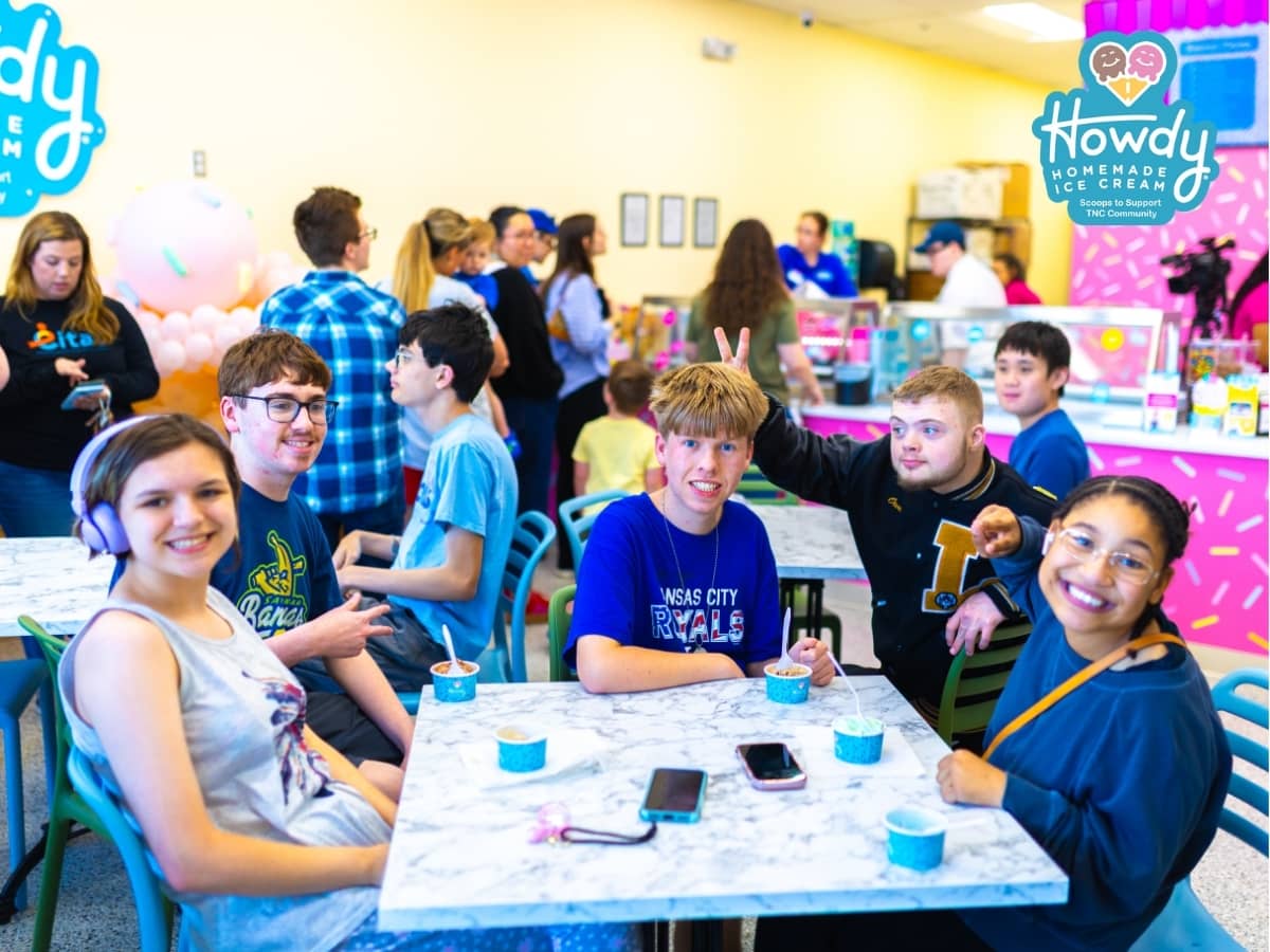 Howdy Homemade Ice Cream shop interior with a group of young guests enjoying their scoops together