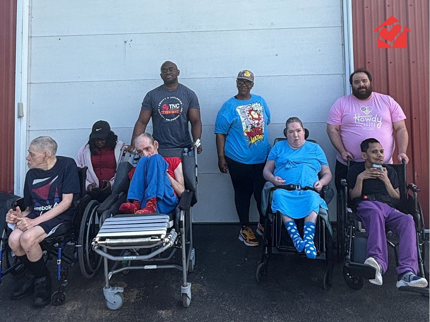 TNC Community individuals and their staff by the barn at Spring Fun Day