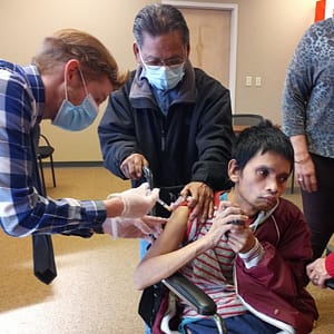 Dennis-shotA TNC Community individual receives COVID-19 vaccination