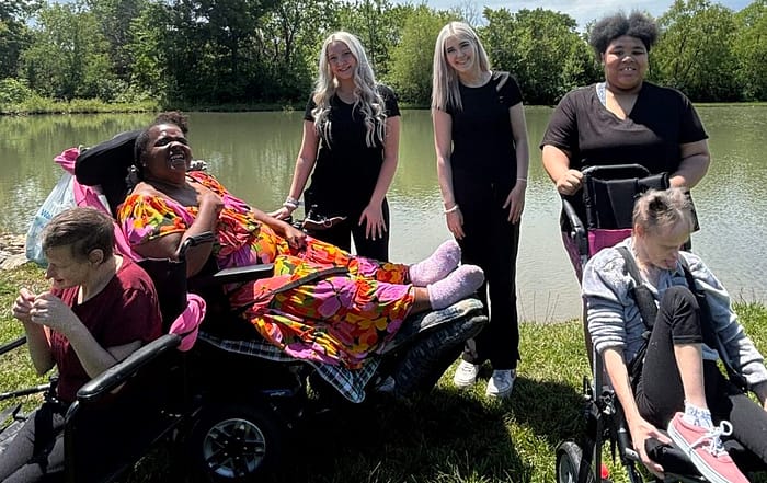 TNC Community individuals and staff by the pond at Spring Fun Day.